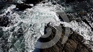 Ocean Water Swirls As Seen From Above Rock