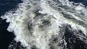 Ocean water wave ship trail with white foamy.