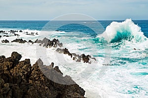 Ocean wave splashing rock shore