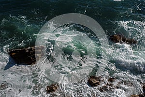 Ocean wave background breaking sea water rocky shore