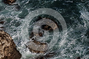 Ocean wave background breaking sea water rocky shore