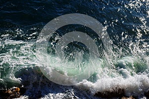 Ocean wave background breaking sea water rocky shore