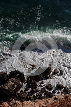 Ocean wave background breaking sea water rocky shore