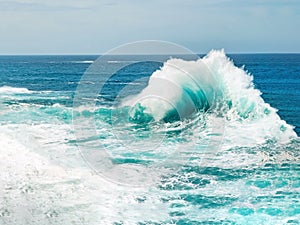 Ocean wave breaking the sea water
