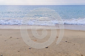 Ocean wave close and sand beach background