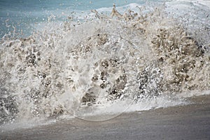 An ocean wave full of sand photo