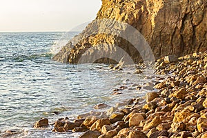 Ocean wave meeting cliff edge along rocky shoreline