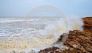 Ocean Wave Striking with Rocks and Sprinkle of Water Drops - Sea Spray Abstract Natural Background