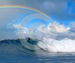 Ocean wave in tropical paradise and rainbow