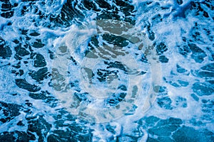 Ocean wave water sea of rippled water with white wave bubbles near the big boat on summer