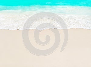 Ocean wave and white sand at tropical beach, island Praslin, Seychelles