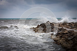 Ocean waves against a rocky coast on a stormy day