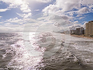 Ocean waves on the beach with bright sun