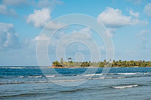 Ocean waves blue sky and palm tree island coast -
