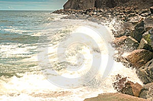 Ocean Waves breaking against rocky shoreline