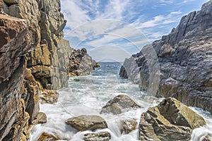 Ocean waves crashing against a rocky shore- slow shutterspeed