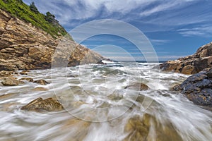 Ocean waves crashing against a rocky shore- slow shutterspeed