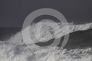 Ocean waves crashing against rocky shoreline, dramatic seascape