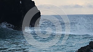 Ocean waves crashing on the cliffy shore, in Watamu Beach, Kenya, at d