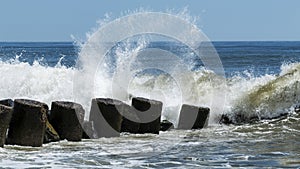 Ocean waves crashing into jetty