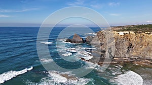 Ocean waves crashing on the rocks. Odeceixe Mar Beach, Portugal