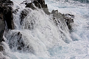 Ocean waves crashing on rocky shoreline