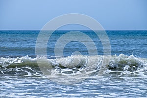 Ocean waves crashing on sandy beach. Sea waves breaking on Maditerranean\'s shore