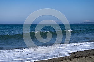 Ocean waves crashing on sandy beach. Sea waves breaking on Maditerranean\'s shore