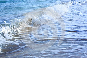 Ocean waves crashing on sandy beach. Sea waves breaking on shore. Nature splash on summer day. Sea wave crashing on