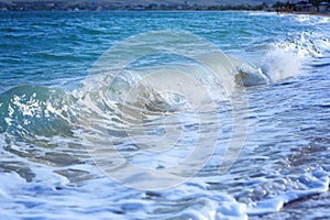 Ocean waves crashing on sandy beach. Sea waves breaking on shore. Nature splash on summer day. Sea wave crashing on