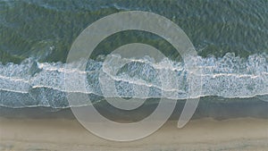 Ocean Waves Crashing on Sandy Beach Shoreline Aerial View