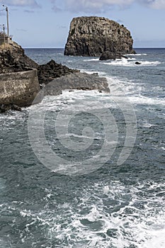Ocean waves dashing on volcanic cliffs at Porto de Cruz, Madeira