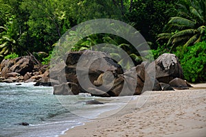 Ocean waves and granite rocks - Baie Lazare beach, Mahe Island, Seychelles.