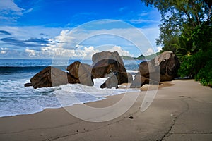 Ocean waves and granite rocks - Baie Lazare beach, Mahe Island, Seychelles. photo