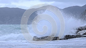 Ocean waves hitting against the rocks on a stormy day