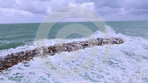 Ocean waves hitting against the rocks on a stormy day