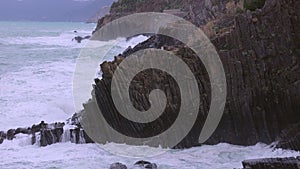 Ocean waves hitting against the rocks on a stormy day