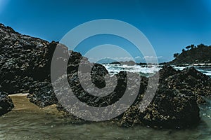 Ocean waves hitting the big rocks at the shore