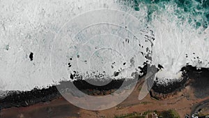 Ocean waves hitting coastline rocks