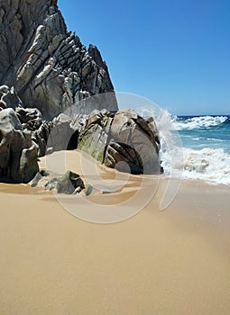 Ocean waves and picturesque rocks and on Divorce beach - a small beach on the bay side in Cabo San Lucas. Mexico