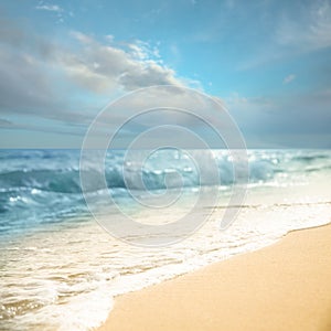 Ocean waves rolling on sandy beach under sky with clouds