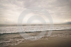 Ocean waves on Santa Monica beach in cloudy november day