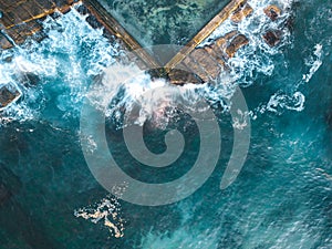 Ocean waves splash onto rocks and into the tidal pool