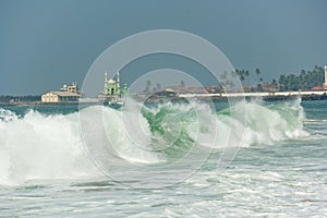 Oceanic wave and minaretes at background photo