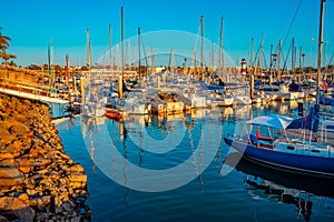 Oceanside Harbor is filled with boats and a lighthouse stands on guard in the background