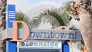 Oceanside nameboard sign and palm trees. Oside is the popular american tourist resort, pacific ocean west coast, San
