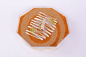 Octagon-shaped Knafeh dessert isolated on a white background