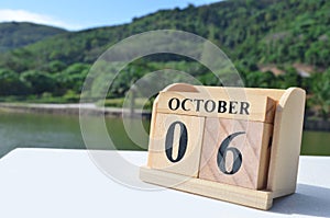 October 06, Date design with number cube on white table, cover design in the natural concept.