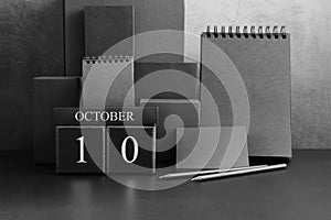 October 10th. Day 10 of month. Wood cube calendar with date month and day.