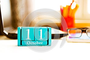 October 11th. Day 11 of month, calendar on human-resources manager workplace background.